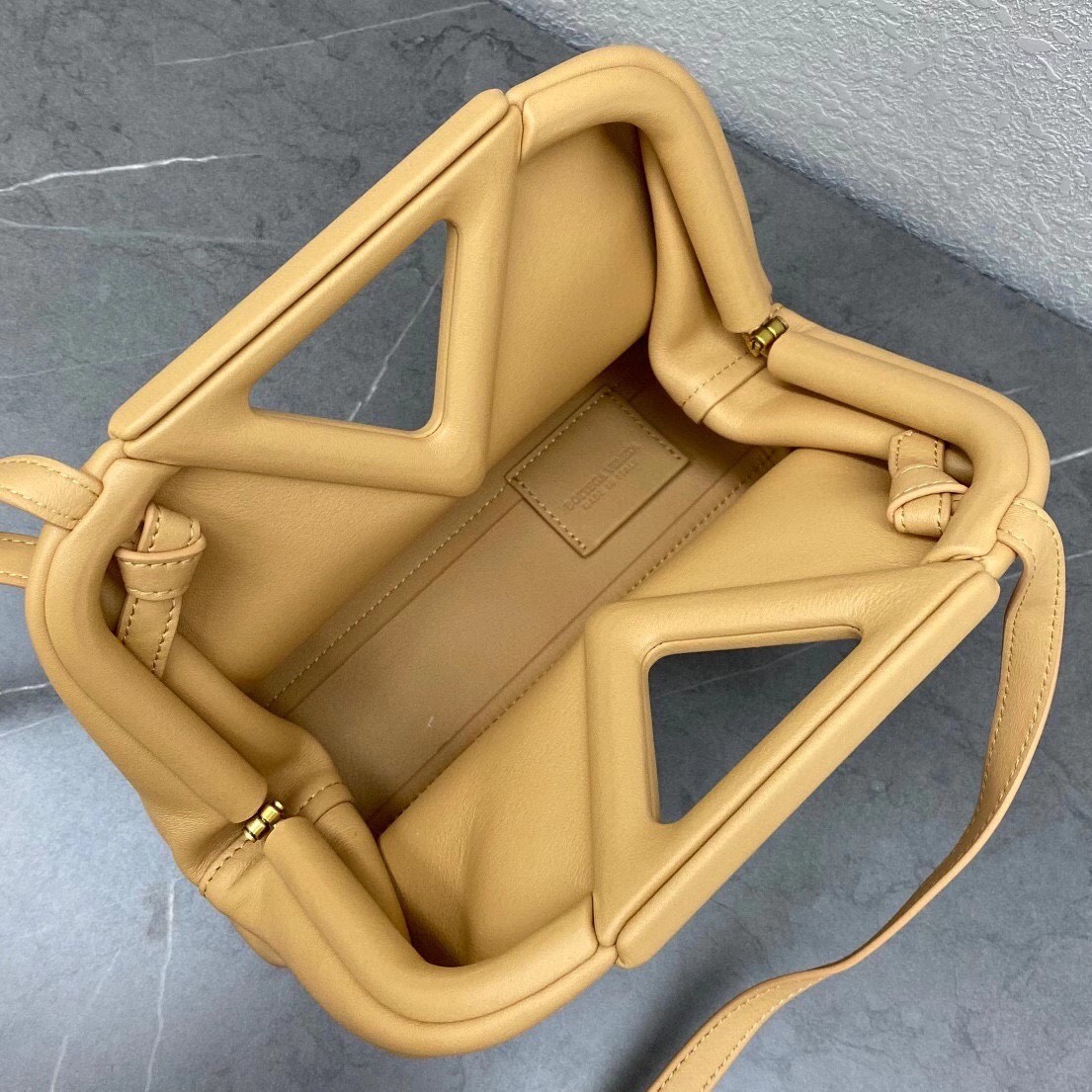 bo*te*ga Ve*ne*ta small point top handle bag in beige leather