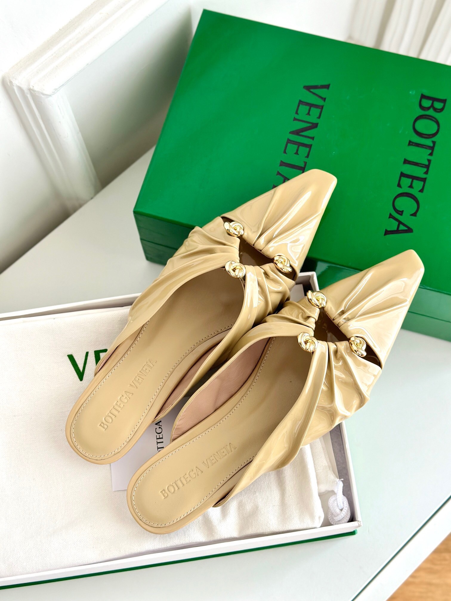 bo*te*ga Ve*ne*ta bunnie flat mules in beige patent leather