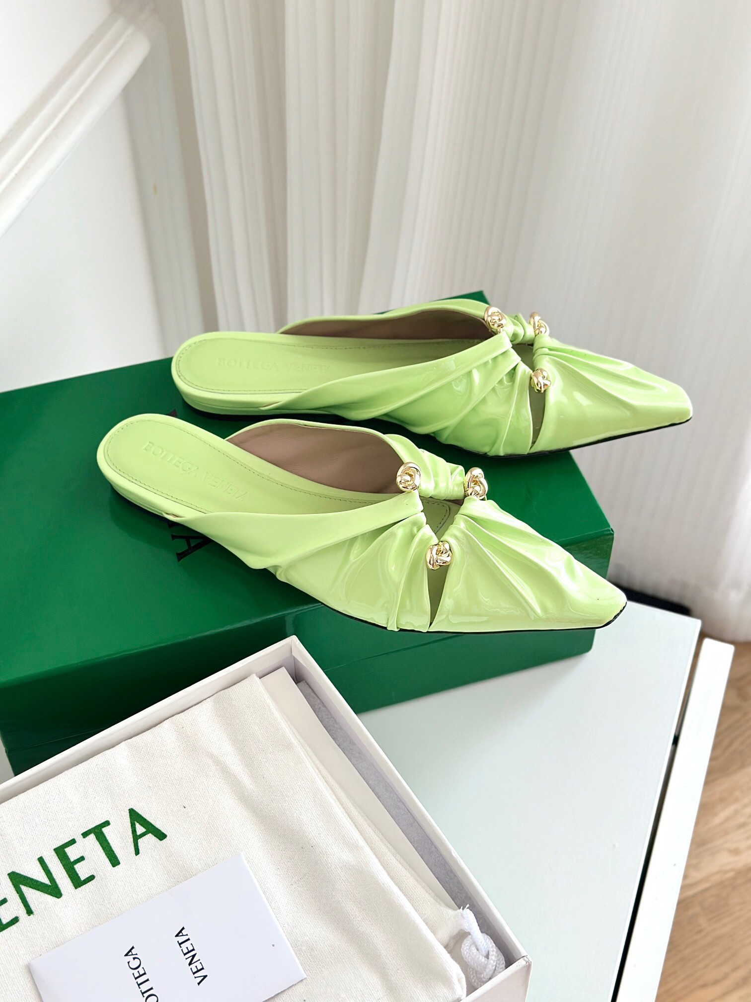 bo*te*ga Ve*ne*ta bunnie flat mules in fennel patent leather