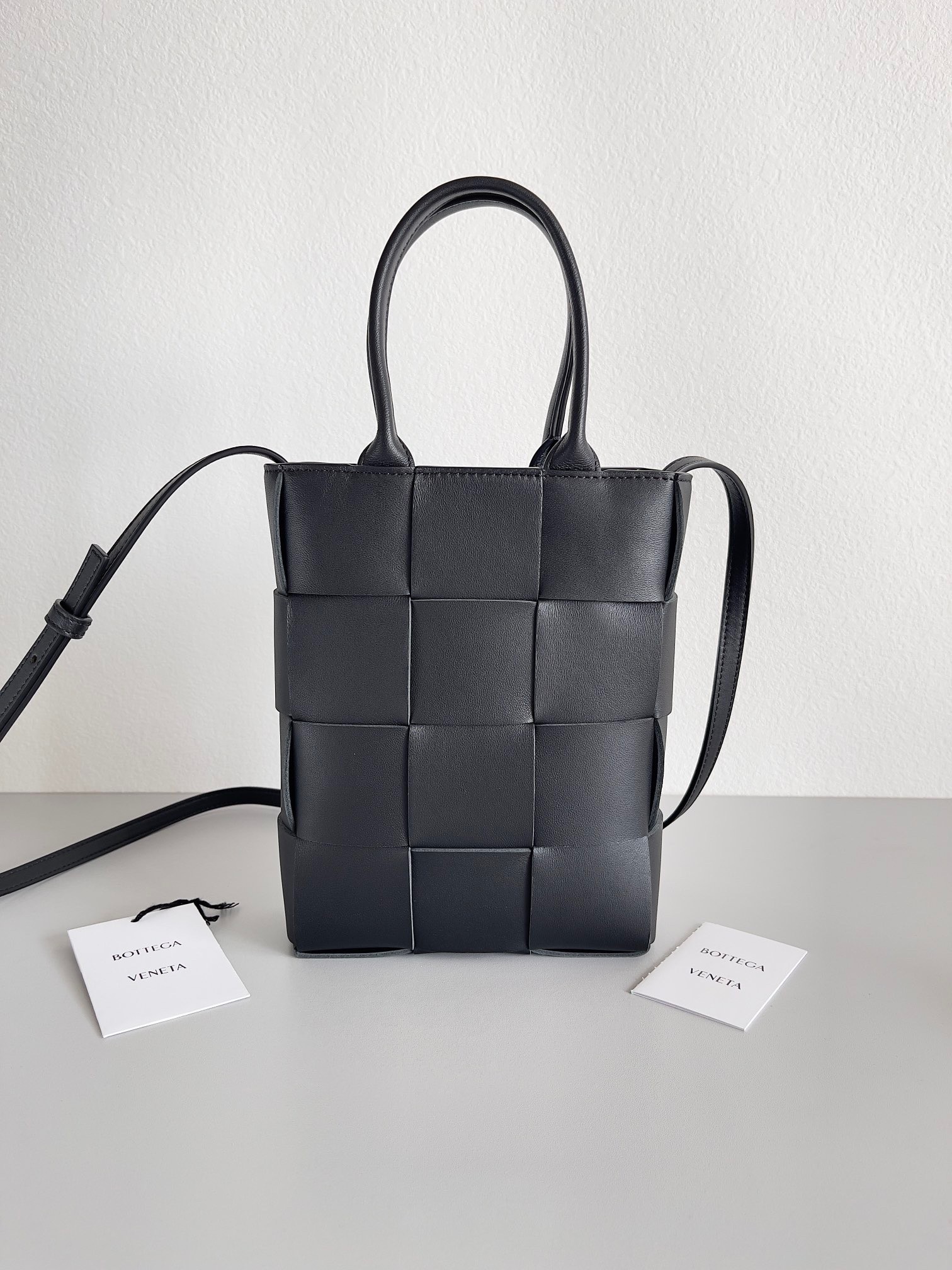 bo*te*ga Ve*ne*ta mini cassette tote bag in black lambskin