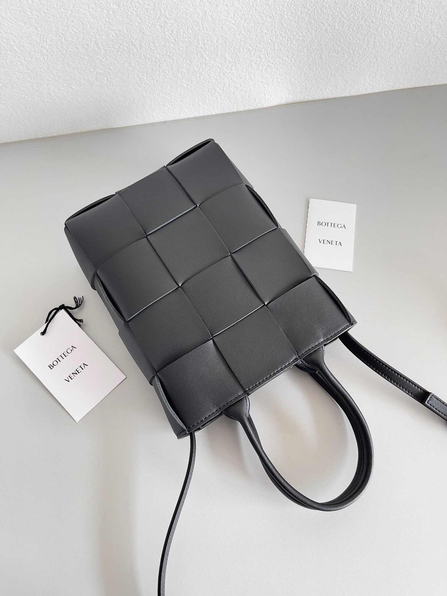 bo*te*ga Ve*ne*ta mini cassette tote bag in black lambskin