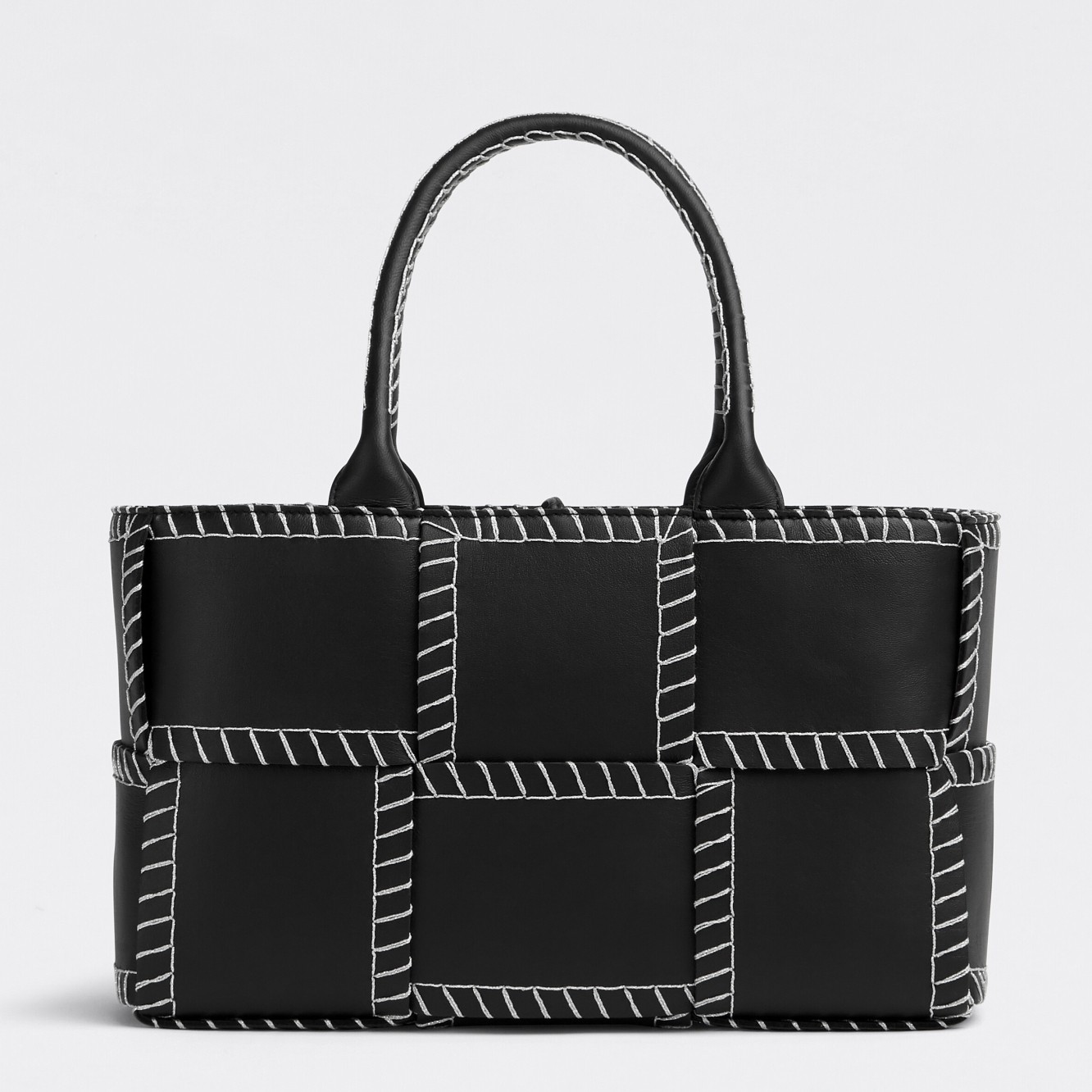 bo*te*ga Ve*ne*ta black arco small tote with white overlock stitching