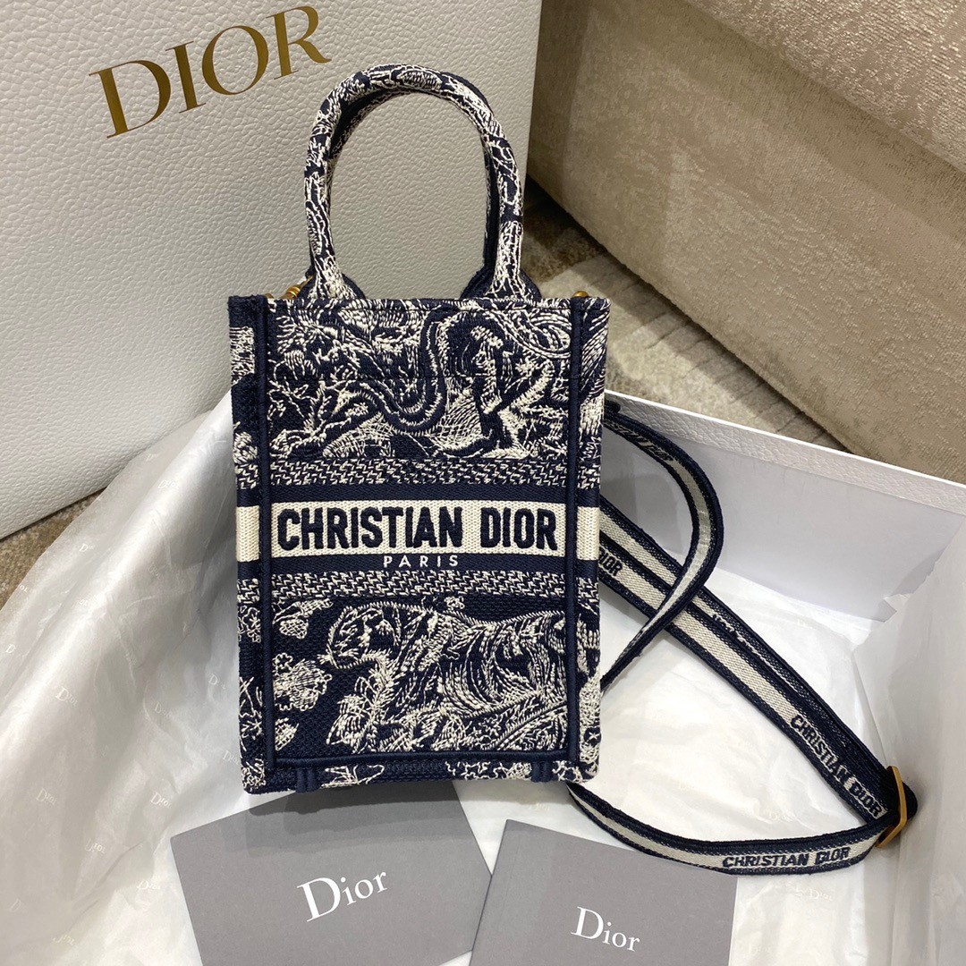 D*or mini book tote phone bag in blue toile de jouy reverse embroidery