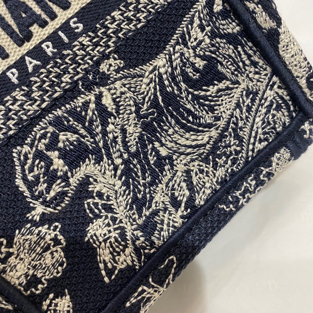 D*or mini book tote phone bag in blue toile de jouy reverse embroidery