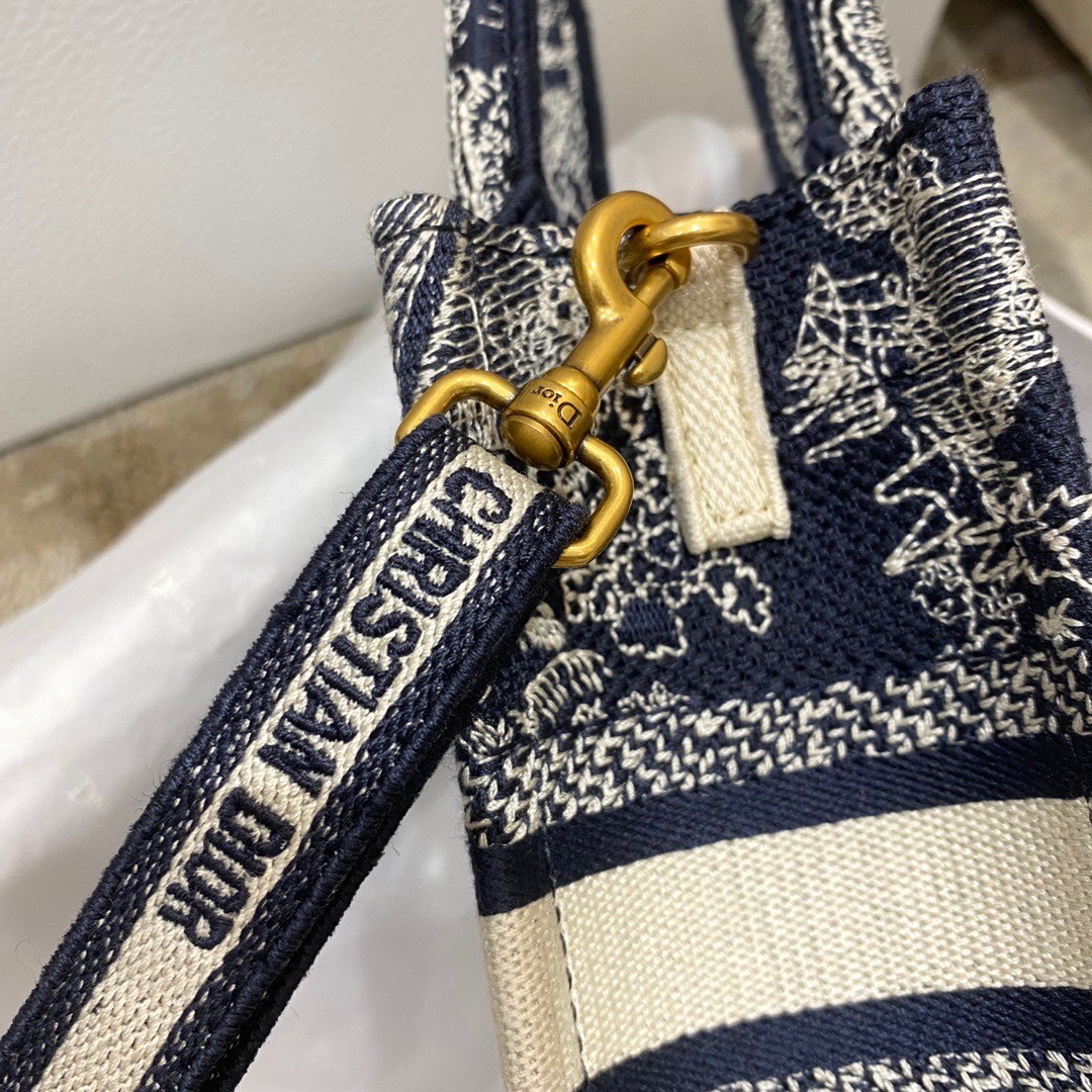 D*or mini book tote phone bag in blue toile de jouy reverse embroidery