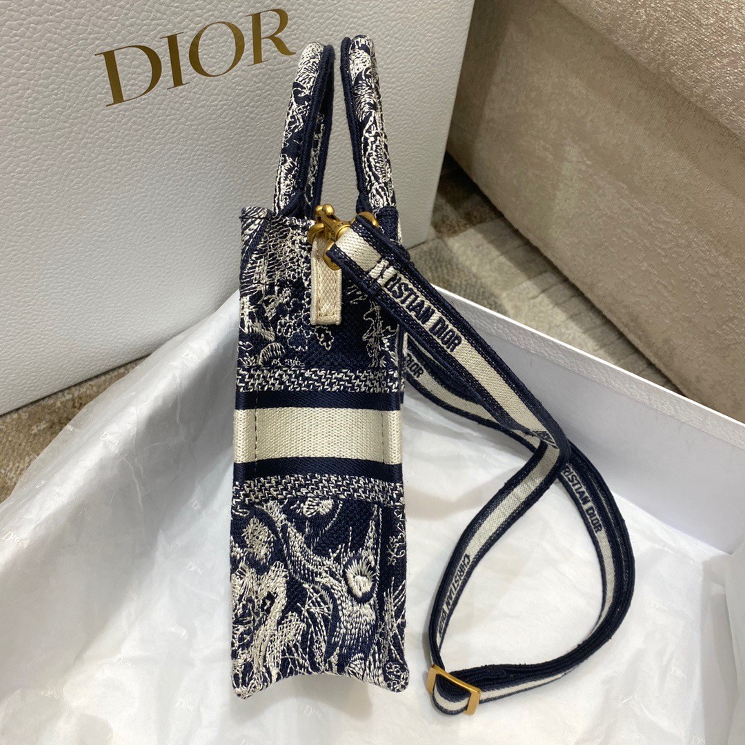 D*or mini book tote phone bag in blue toile de jouy reverse embroidery