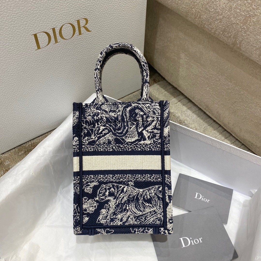 D*or mini book tote phone bag in blue toile de jouy reverse embroidery