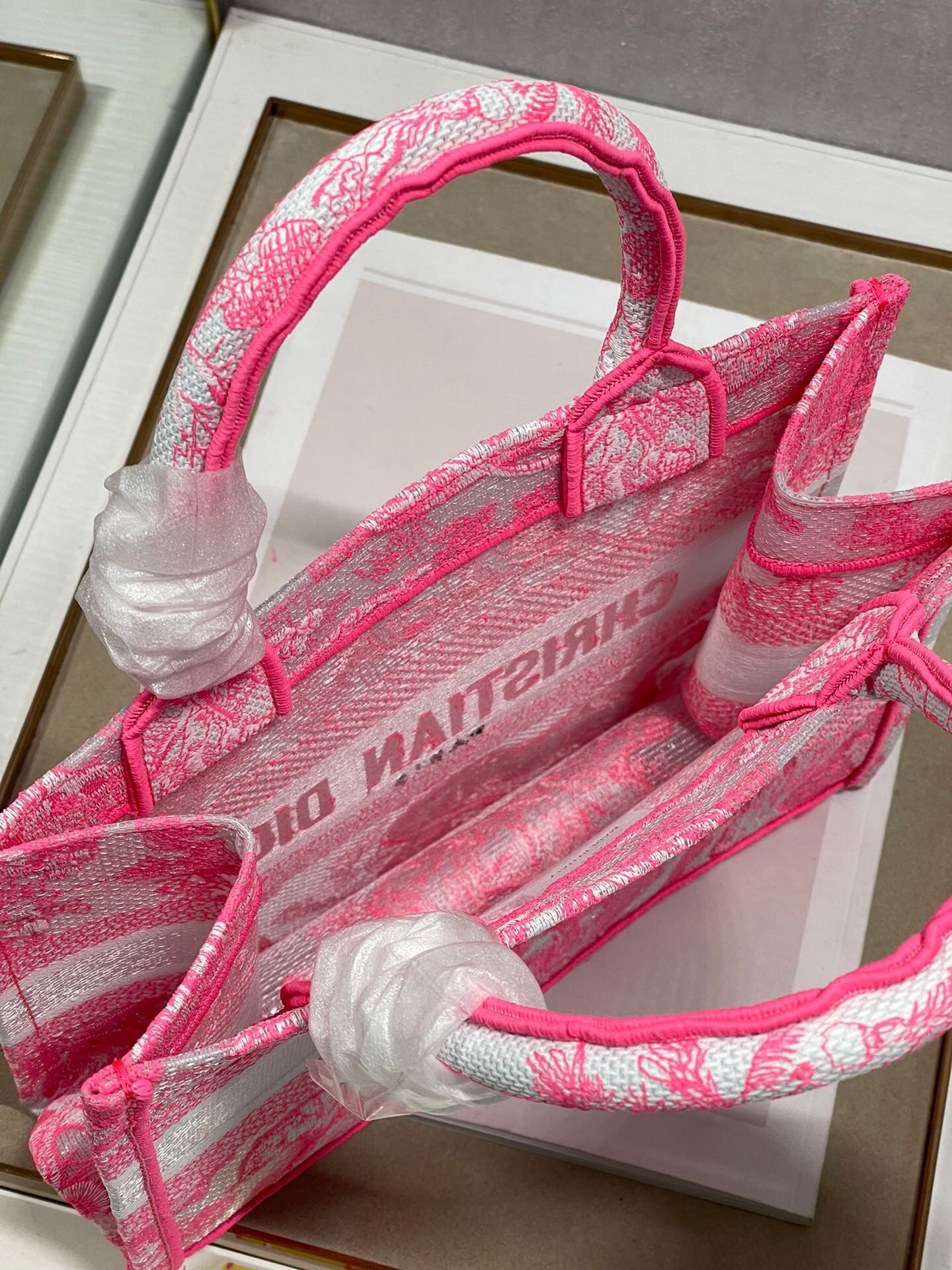 D*or small book tote bag in pink transparent toile de jouy canvas