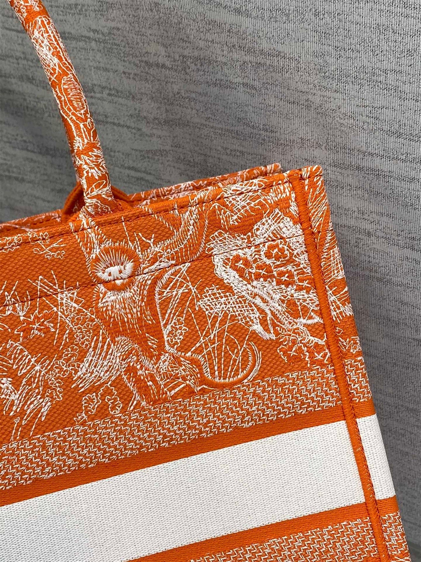 D*or medium book tote bag in fluorescent orange toile de jouy reverse embroidery