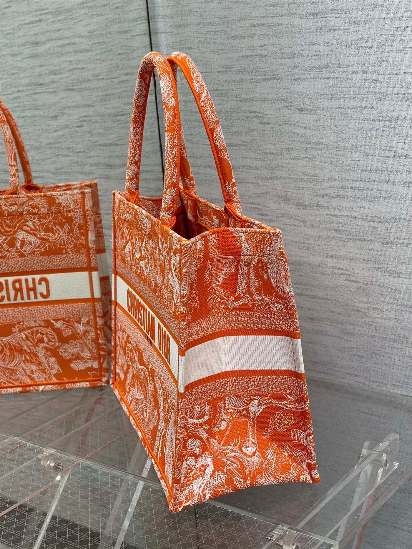 D*or medium book tote bag in fluorescent orange toile de jouy reverse embroidery