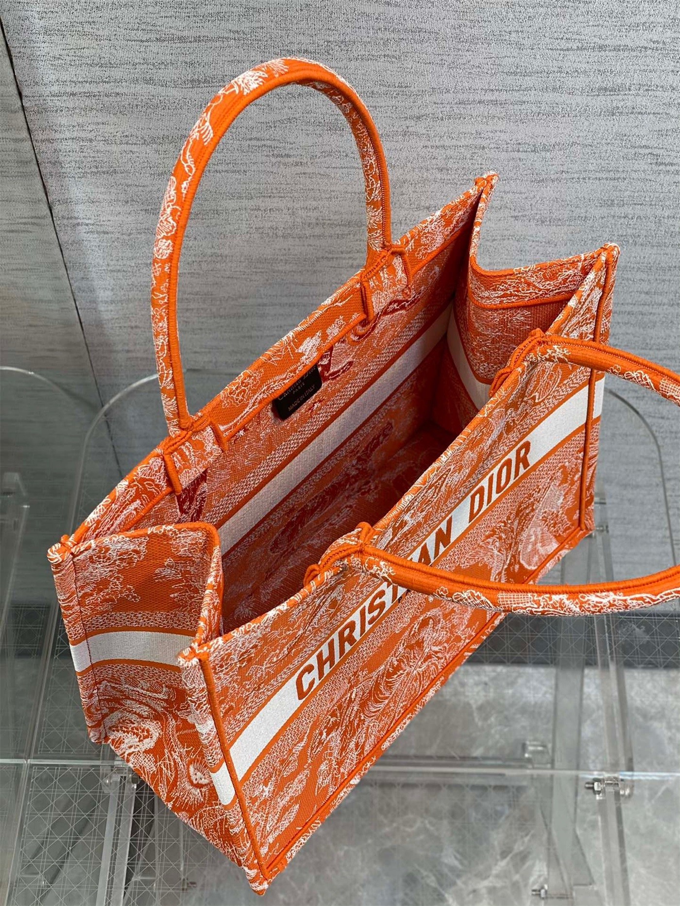 D*or medium book tote bag in fluorescent orange toile de jouy reverse embroidery