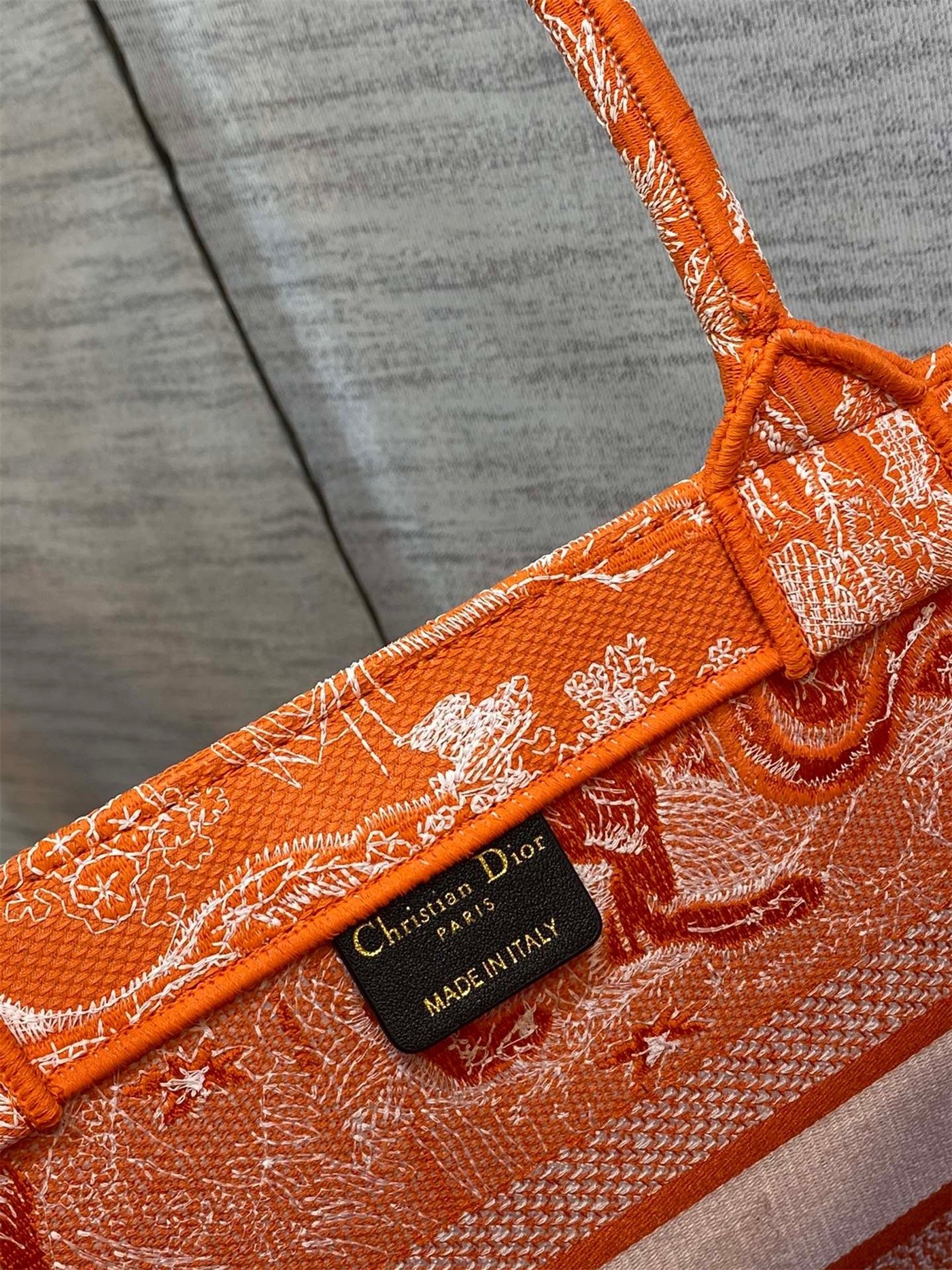 D*or medium book tote bag in fluorescent orange toile de jouy reverse embroidery