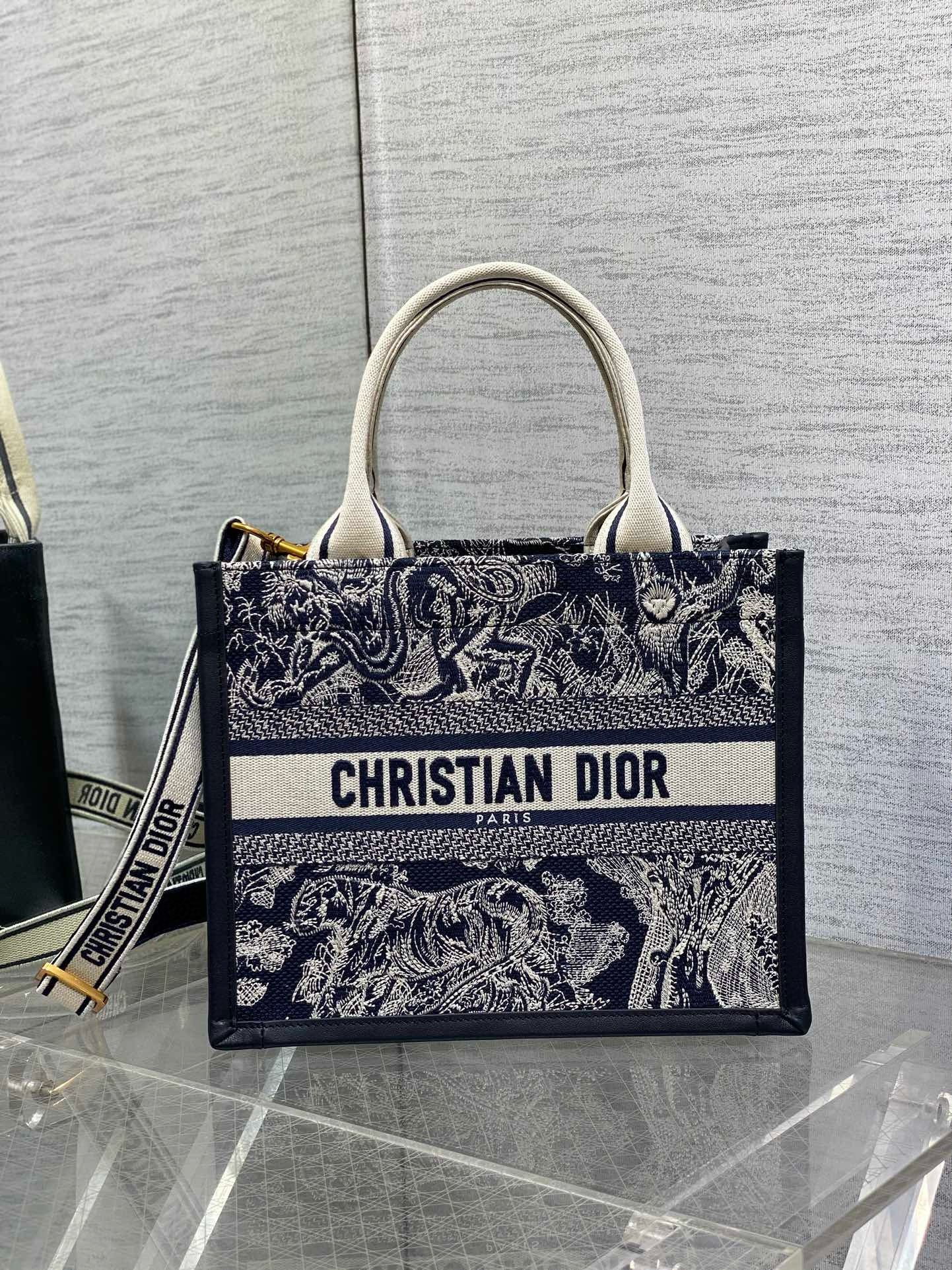 D*or small book tote bag with strap in toile de jouy reverse embroidery and blue calfskin