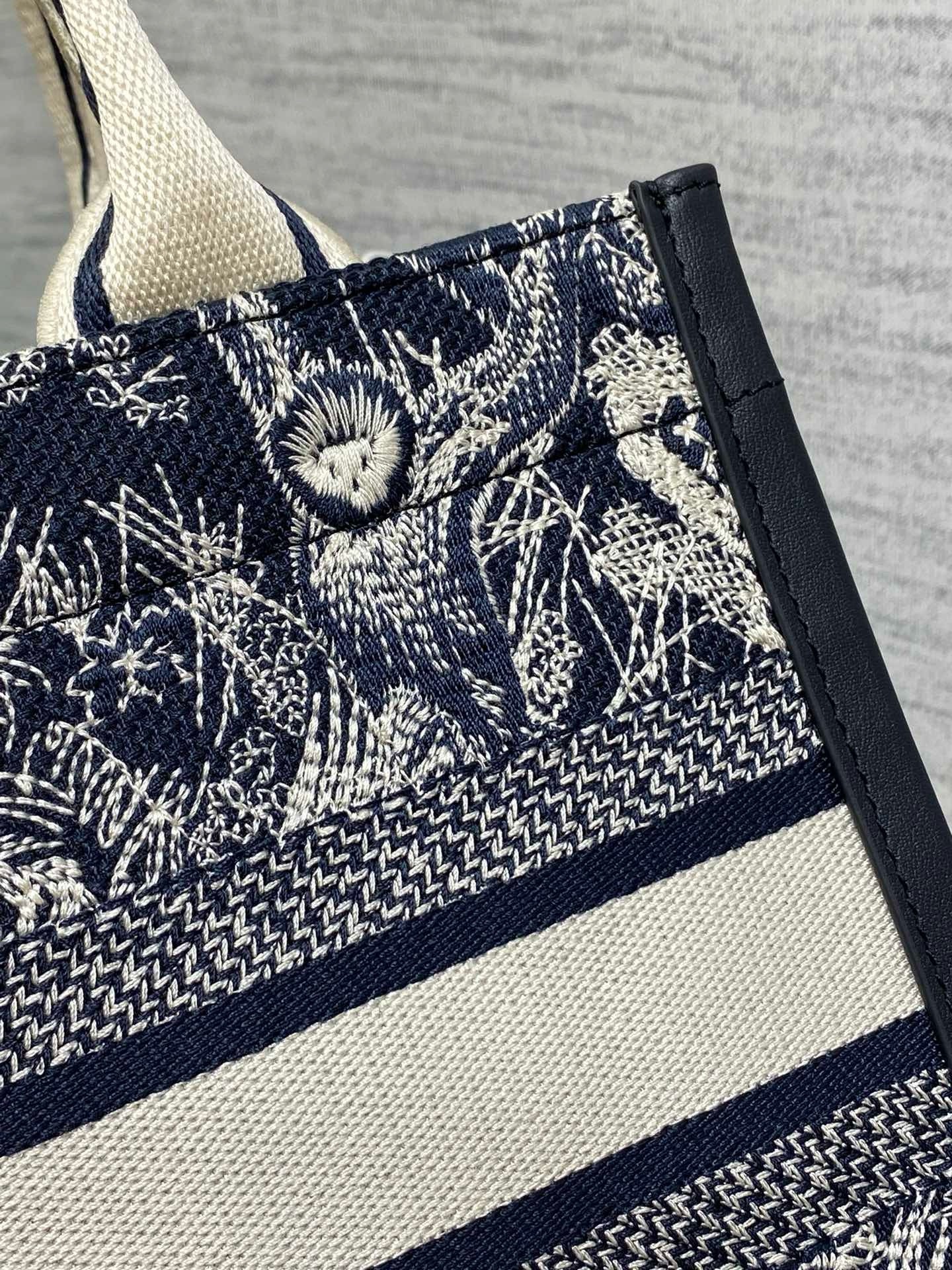D*or small book tote bag with strap in toile de jouy reverse embroidery and blue calfskin