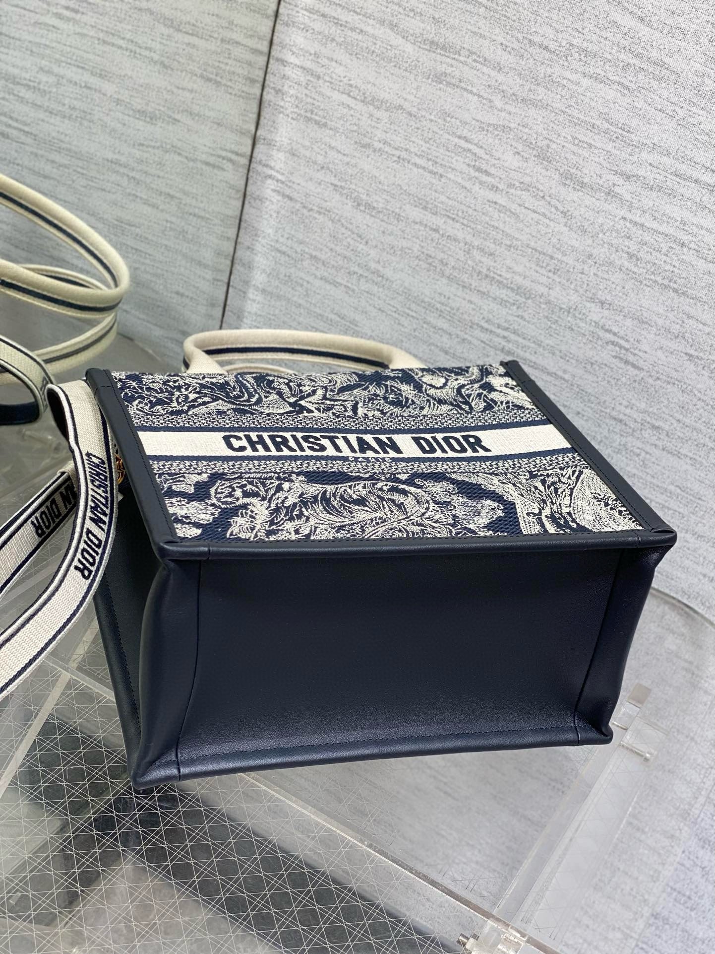 D*or small book tote bag with strap in toile de jouy reverse embroidery and blue calfskin