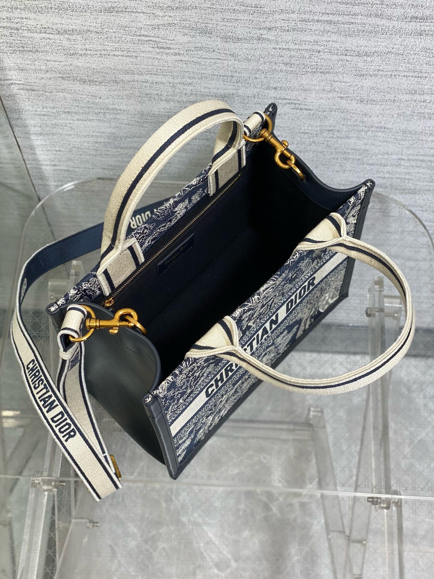 D*or small book tote bag with strap in toile de jouy reverse embroidery and blue calfskin