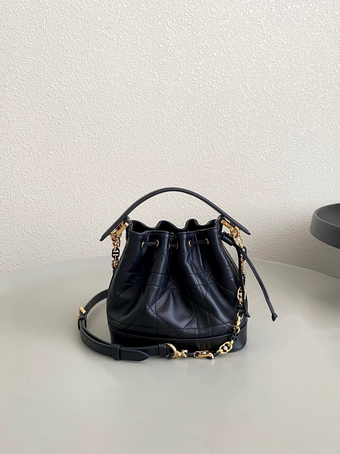 D*or small jolie bucket bag in black macrocannage lambskin