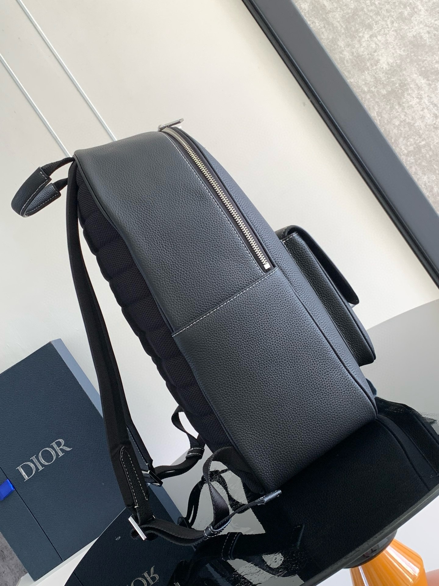 D*or saddle zip backpack in black grained calfskin