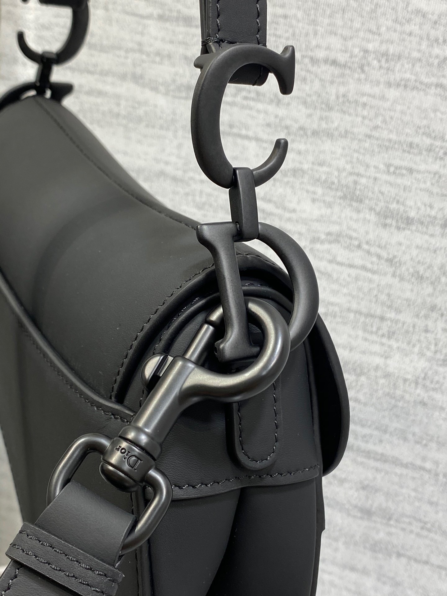 D*or mini saddle bag with strap in black ultramatte calfskin