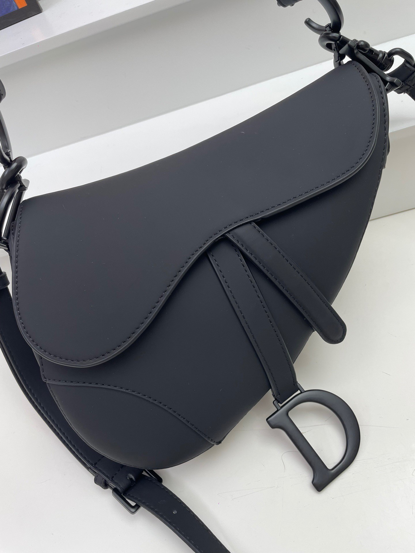 D*or saddle bag with strap in black ultramatte calfskin
