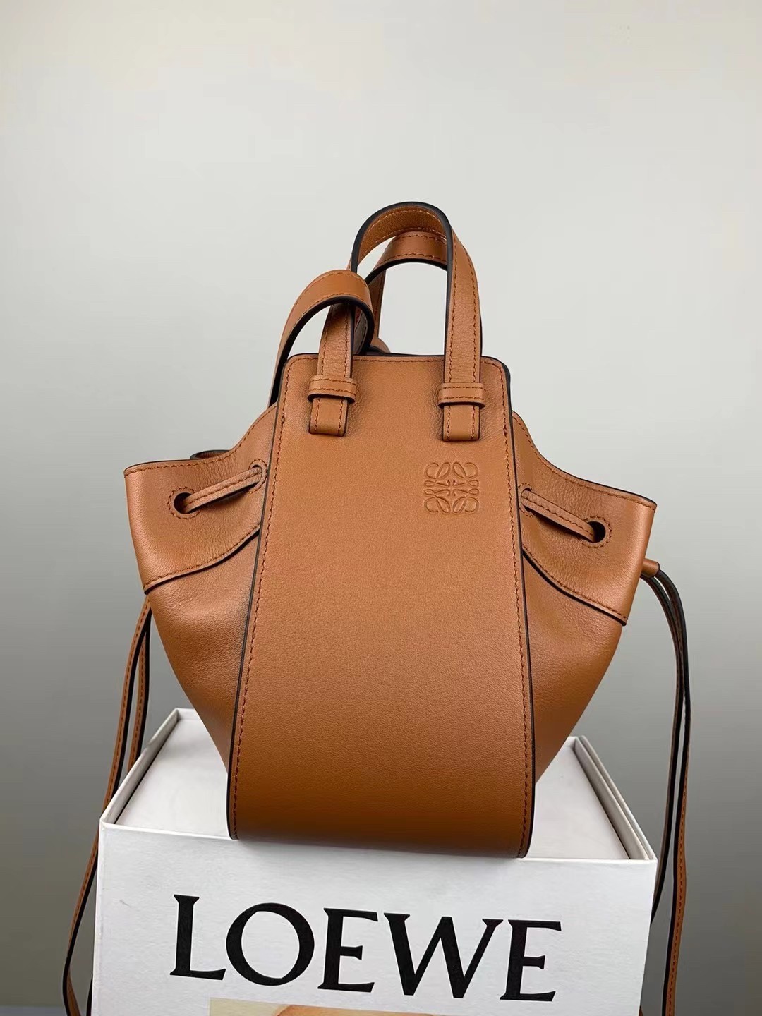 L0ew* mini hammock drawstring bag in brown calfskin