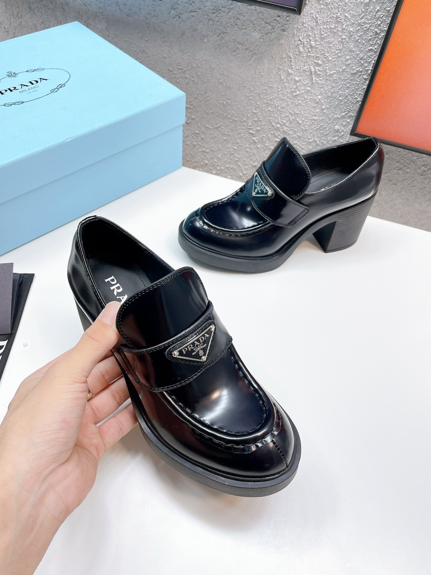 Pra*a chocolate high-heeled loafers in black brushed leather