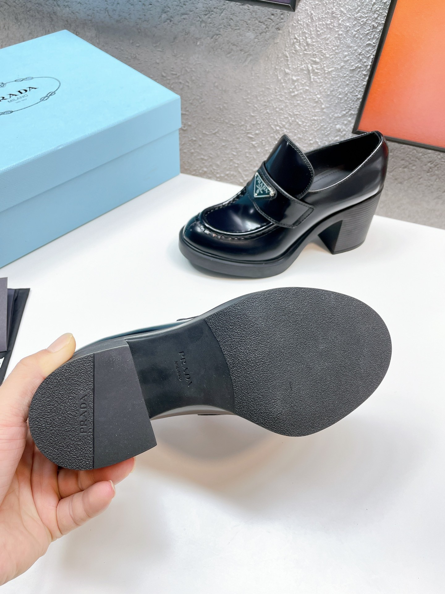 Pra*a chocolate high-heeled loafers in black brushed leather