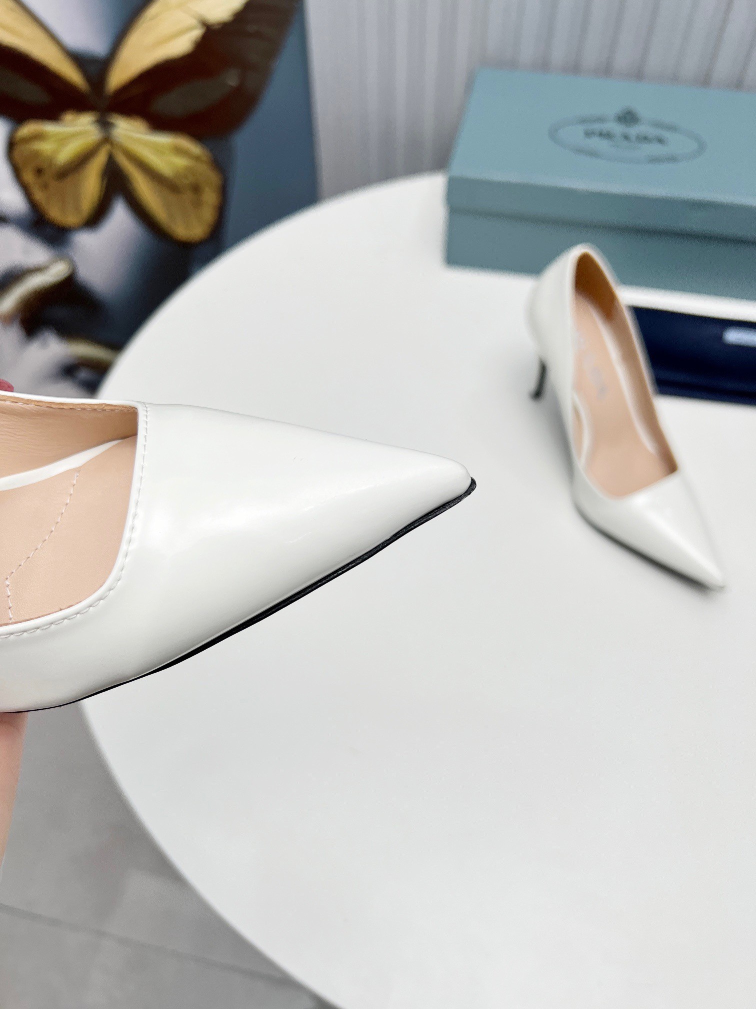 Pra*a pumps 95mm in white patent leather