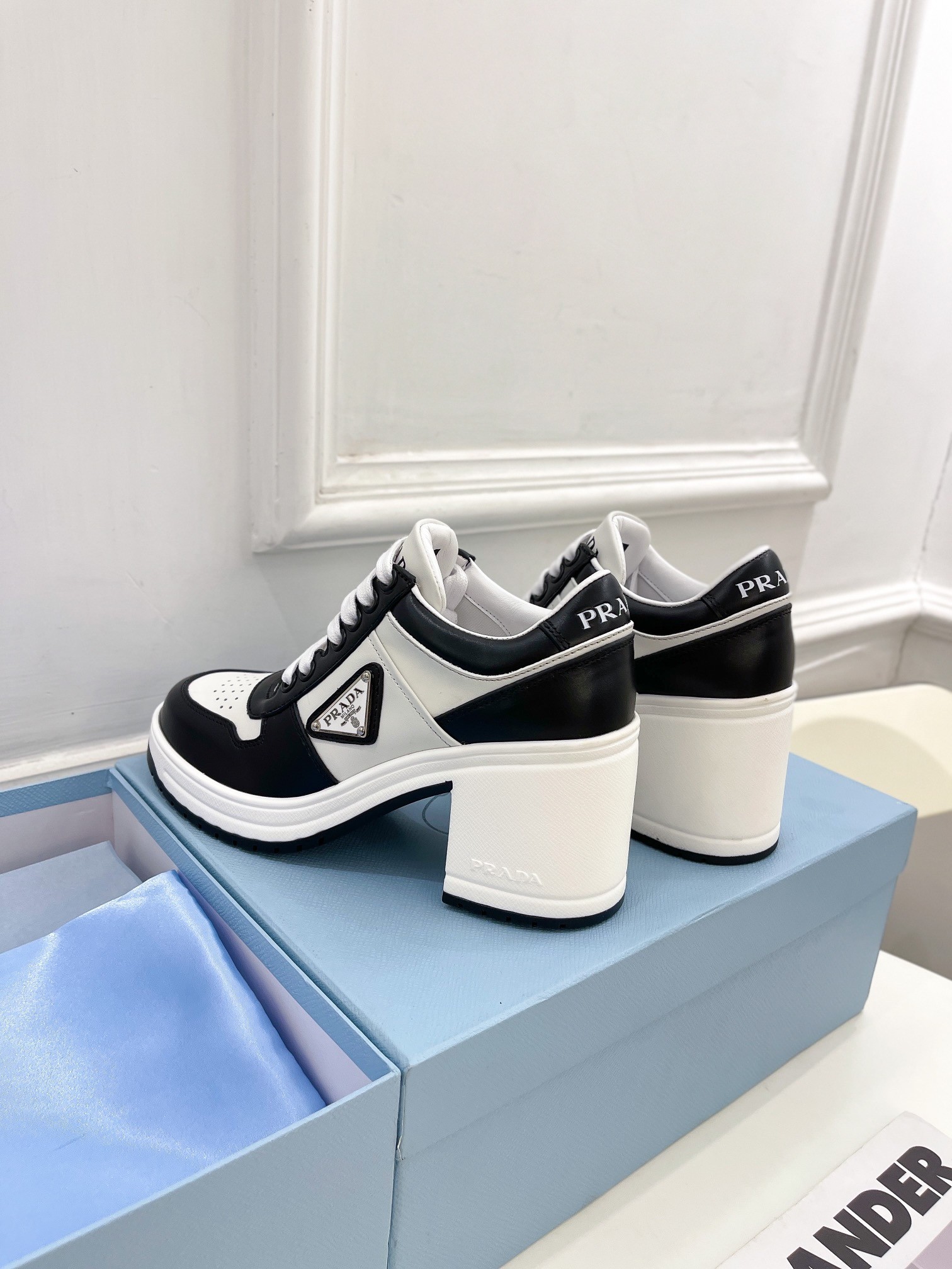 Pra*a downtown high-heeled sneakers in black and white leather