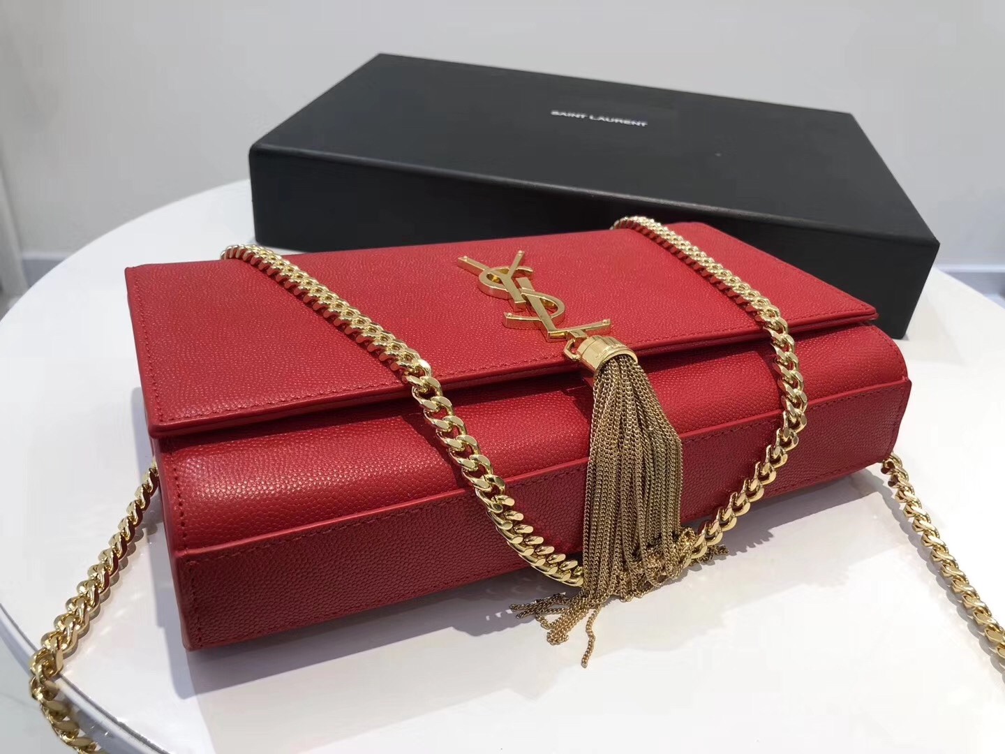 Sa**t Lau*nt medium kate bag with tassel in red grained leather