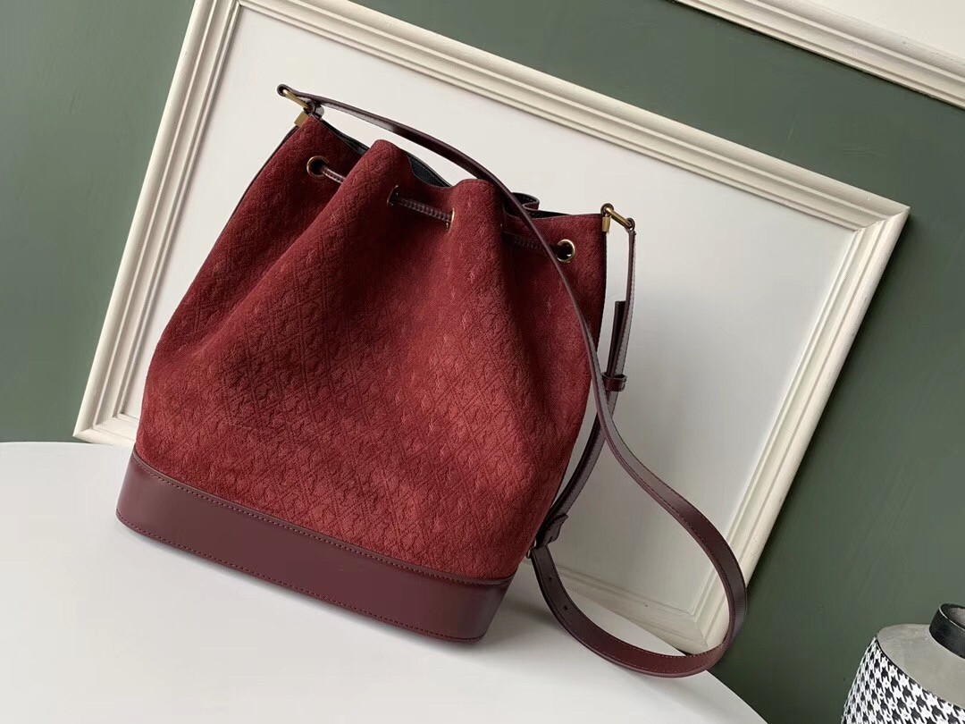 Sa**t Lau*nt monogram all over bucket bag in bordeaux suede