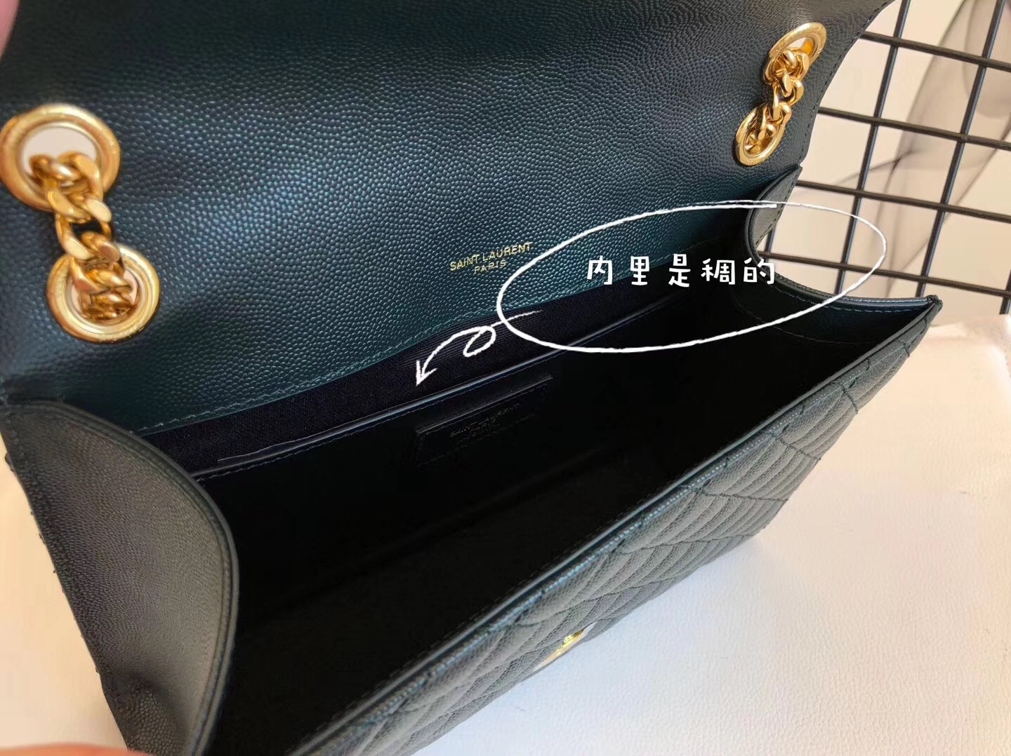 Sa**t Lau*nt medium envelope bag in dark green grained leather